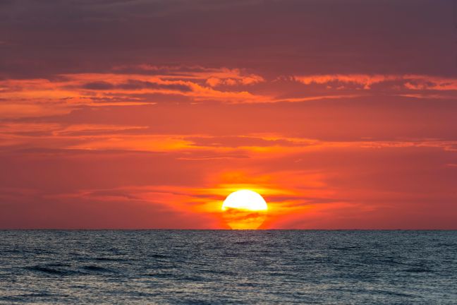 The sun setting over the sea